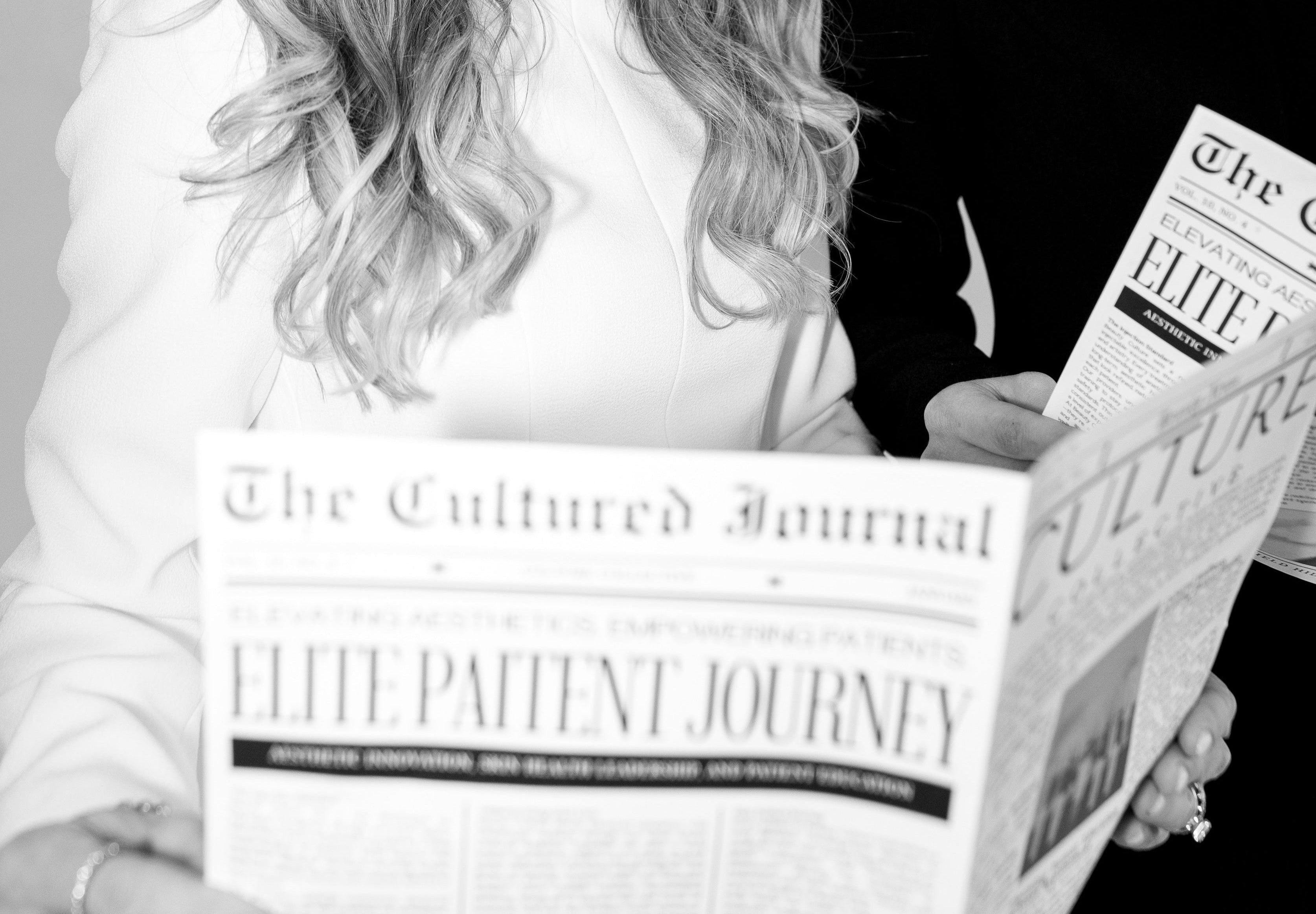 Two people reading newspapers titled 'The Cultured Journal' and 'The Cultured Elite Patient Journey'.